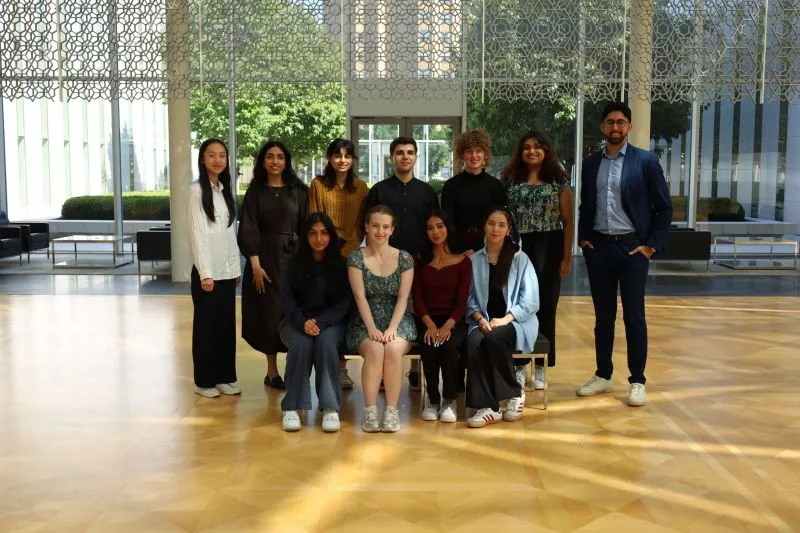 Members of Aga Khan Foundation Canada’s Youth Advisory Committee posed in a sunlit atrium.